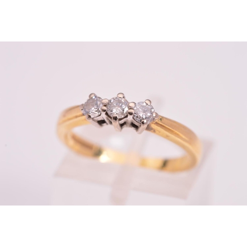 132 - AN 18CT GOLD THREE STONE DIAMOND RING, designed with three brilliant cut diamonds each within four c... 