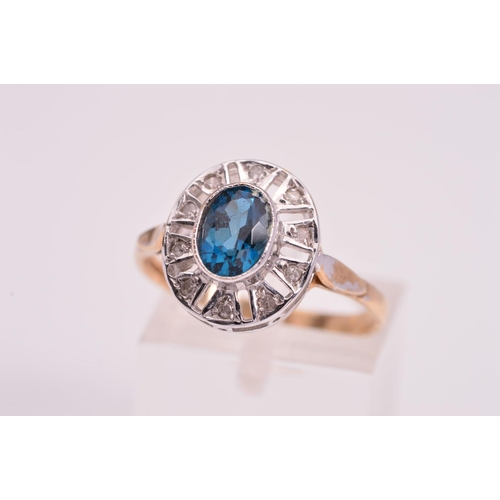 134 - A 9CT GOLD DIAMOND DRESS RING, designed with a central oval blue gem assessed as coated topaz, withi... 