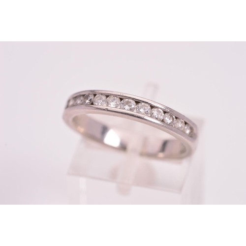 135 - A DIAMOND HALF ETERNITY RING, designed with twelve brillaint cut diamonds channel set to the plain p... 