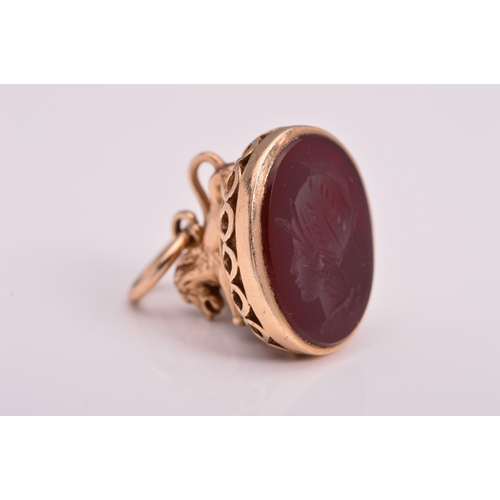 139 - A 9CT GOLD ITAGLIO FOB, designed with a lion grip to the oval carnelian seal carved to depict a sold... 