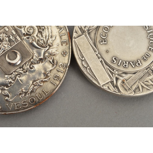 372 - TWO HEAVY GRADE WHITE METAL MEDALLIONS, both French, one is marked 'Ecole de Musique de Paris' with ... 