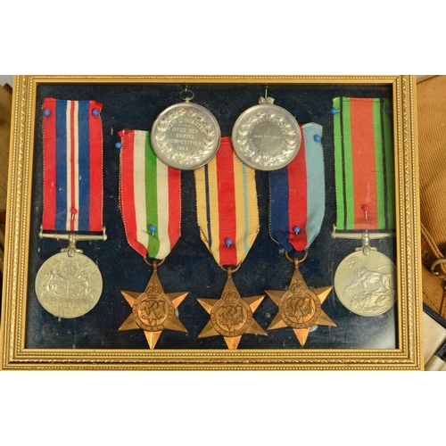 391 - A FRAMED GROUP OF WWII MEDALS, to include 1939-45, Africa, Italy Stars War & Defence medal with two ... 