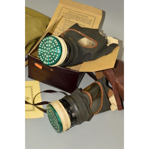 437 - A BOX CONTAINING THREE WWII PERIOD GAS MASKS, contained in green canvas bag marked 1942, contained i... 