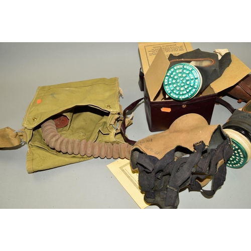 437 - A BOX CONTAINING THREE WWII PERIOD GAS MASKS, contained in green canvas bag marked 1942, contained i... 