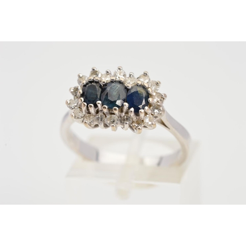 78 - A SAPPHIRE AND DIAMOND CLUSTER RING, designed with three central oval sapphires with single cut diam... 