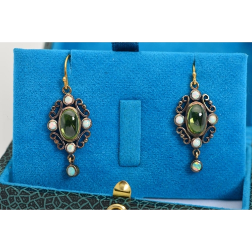 92 - A PAIR OF PERIDOT AND OPAL DROP EARRINGS, each designed as a central oval peridot cabochon within a ... 