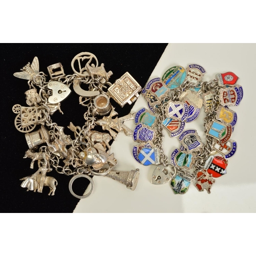 129 - TWO SILVER CHARM BRACELETS, to include a curb link charm bracelet fully set with enamel town shields... 