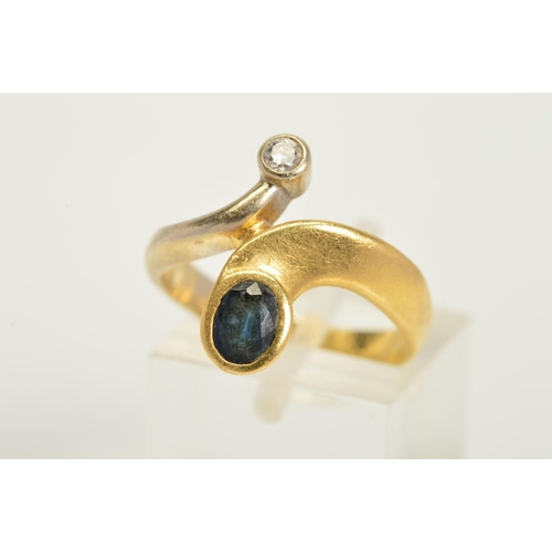 134 - A MODERN DIAMOND AND SAPPHIRE TWO STONE RING, abstract crossover design in satin and polished finish... 
