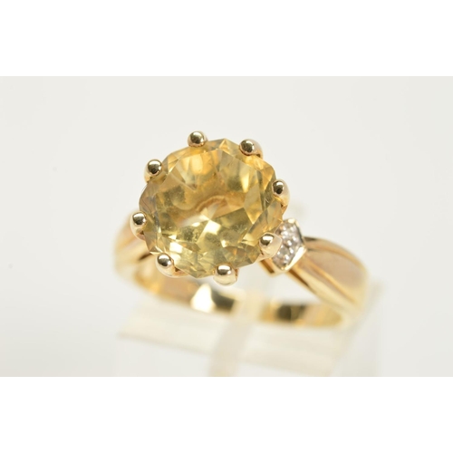137 - A 9CT GOLD CITRINE AND DIAMOND RING, designed as a central circular citrine within an eight claw set... 