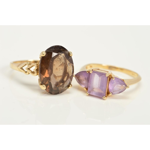 142 - TWO GOLD GEM SET RINGS, the first a 9ct gold ring set with a central oval smokey quartz and open hea... 