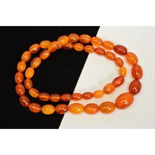 154 - A NATURAL AMBER NECKLACE, designed as graduated oval shape beads measuring 8mm to 16mm, to the screw... 