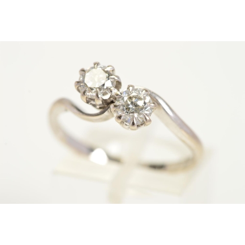 157 - A MID 20TH CENTURY TWO STONE DIAMOND CROSS OVER RING, two brilliant cut diamonds each measuring appr... 