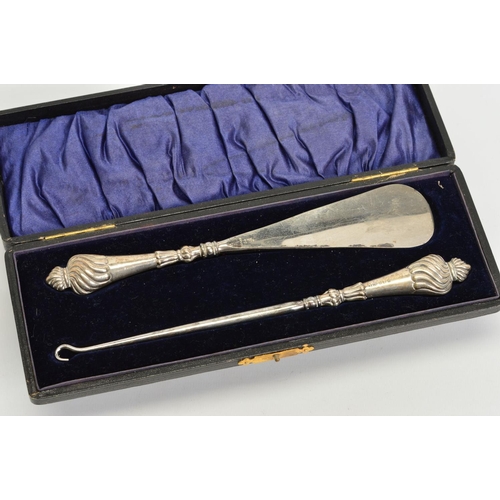 167 - A CASED EDWARDIAN SILVER HANDLED BUTTON HOOK AND SHOE HORN, reeded design, makers Adie & Lovekin Ltd... 