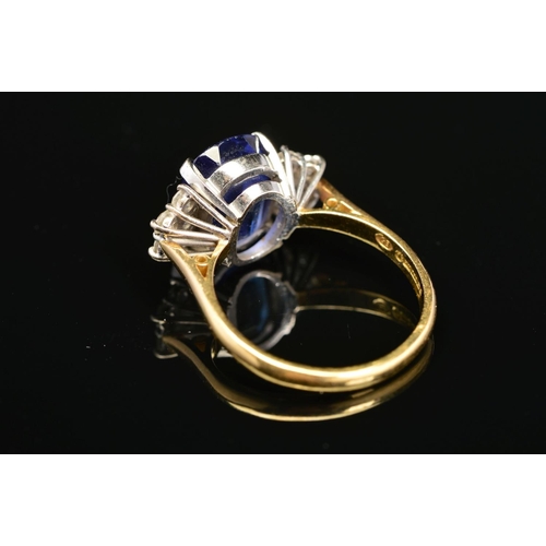 1 - A MODERN 18CT GOLD TANZANITE AND DIAMOND DRESS RING, centring on a principal cushion cut tanzanite m... 