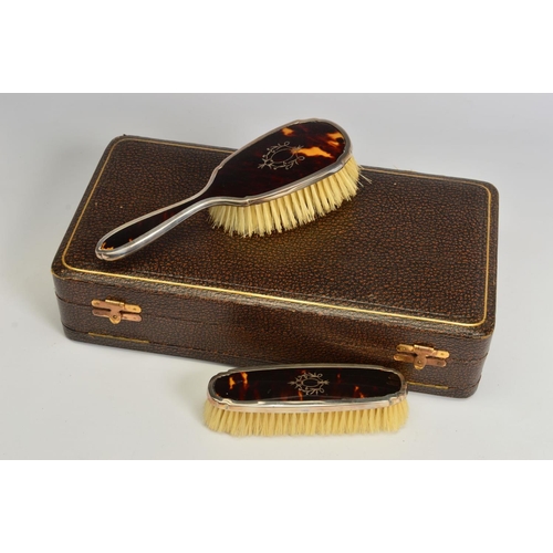 104 - A CASED GEORGE V SILVER AND TORTOISESHELL PIQUE WORK DRESSING TABLE SET, comprising hand mirror, fou... 