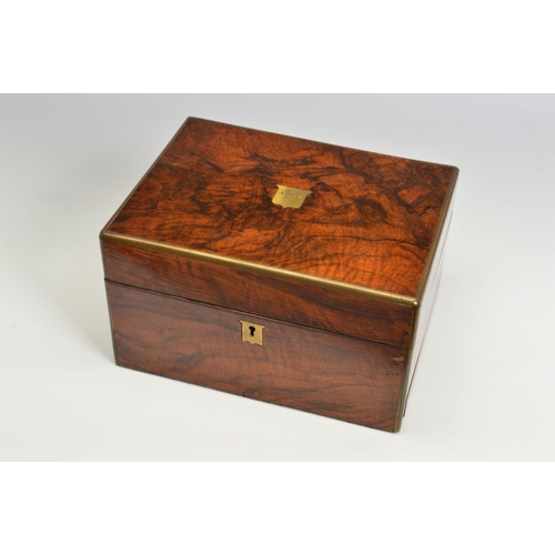 110 - A LATE VICTORIAN WALNUT AND GILT BRASS BOUND DRESSING BOX, of rectangular form, with tooled green le... 