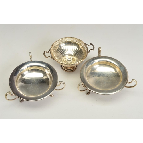 118 - A PAIR OF GEORGE V SILVER BON BON DISHES, of circular form, with three open scrolled handles and scr... 