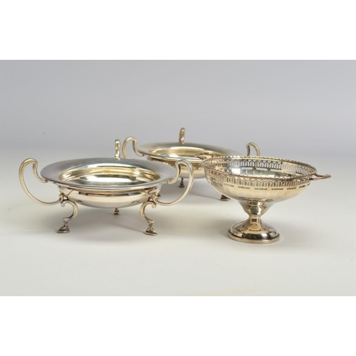 118 - A PAIR OF GEORGE V SILVER BON BON DISHES, of circular form, with three open scrolled handles and scr... 