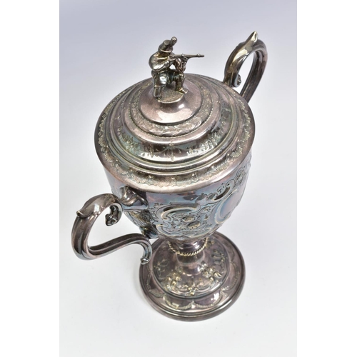 124 - A LATE VICTORIAN SILVER PLATED TWIN HANDLED TROPHY CUP OF MILITARY INTEREST, the pull off cover with... 