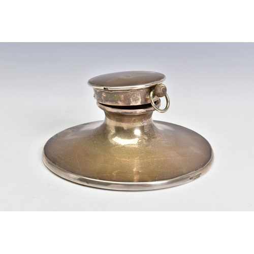 125 - AN EDWARDIAN SILVER CAPSTAN INKWELL, the hinged cover fitted with a top wind pocket watch, the white... 