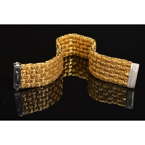 13 - A MODERN 18CT GOLD ROBERTO COIN DIAMOND BRACELET, a wide flat panel link textured pattern with diamo... 