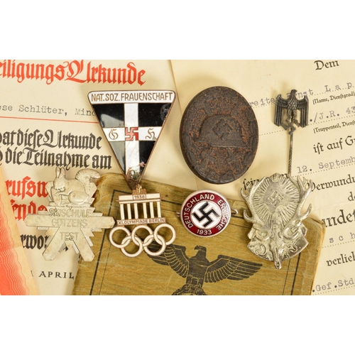 142 - A NUMBER OF GERMAN WWII 3RD REICH MILITARY BADGES AND PAPERWORK, comprising of soldiers 'Soldbuch' 2... 