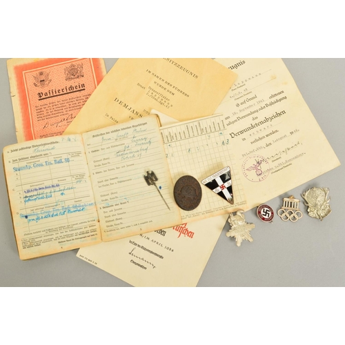 142 - A NUMBER OF GERMAN WWII 3RD REICH MILITARY BADGES AND PAPERWORK, comprising of soldiers 'Soldbuch' 2... 