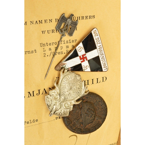 142 - A NUMBER OF GERMAN WWII 3RD REICH MILITARY BADGES AND PAPERWORK, comprising of soldiers 'Soldbuch' 2... 