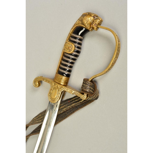 143 - A WWII ERA 3RD REICH OFFICERS SWORD AND SCABBARD, the design is the 'Lions Head' style with red colo... 