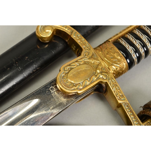 143 - A WWII ERA 3RD REICH OFFICERS SWORD AND SCABBARD, the design is the 'Lions Head' style with red colo... 