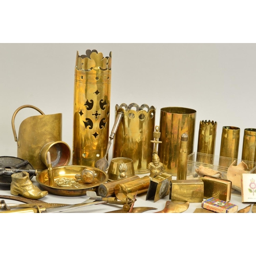 148 - A COLLECTION OF WWI ERA TRENCH ART ITEMS, including shell cases with cut out designs around the rim,... 