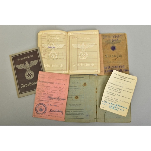 153 - A GROUP OF 3RD REICH WWII MEDALS AND BADGES, plus paperwork relating to two members of the same fami... 