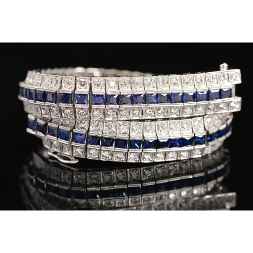 16 - A MODERN SAPPHIRE AND DIAMOND LINE BRACELET, centring on a line of calibre square cut blue sapphires... 