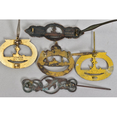 161 - FIVE BADGES AND CLASPS, of German WWII Kreigsmarine U boat interest consisting of gold coloured U bo... 