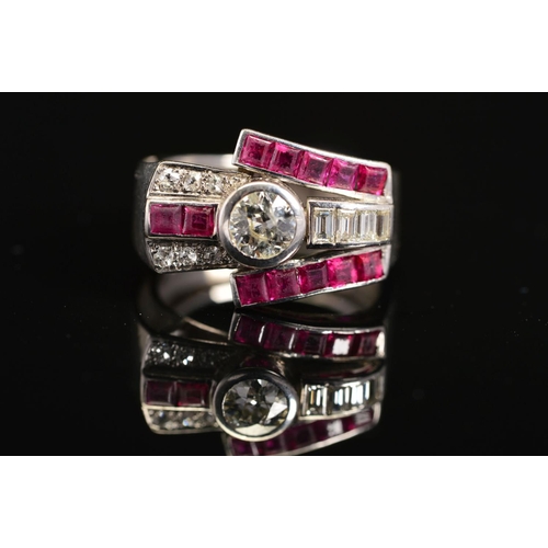 19 - AN EARLY TO MID 20TH CENTURY RUBY AND DIAMOND COCKTAIL RING, centring on an early brilliant cut diam... 