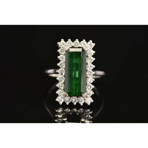 2 - A LATE 20TH CENTURY 18CT GOLD RECTANGULAR SHAPED GREEN TOURMALINE AND DIAMOND CLUSTER RING, an emera... 