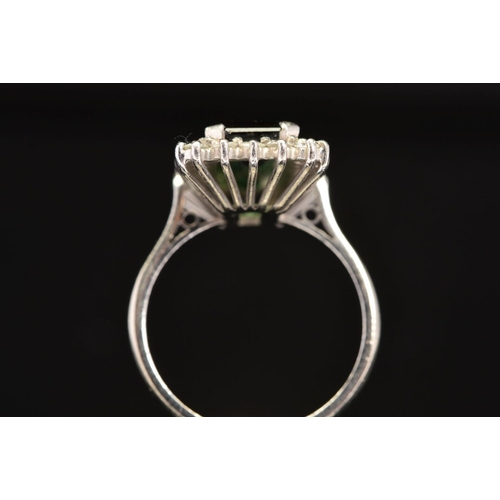 2 - A LATE 20TH CENTURY 18CT GOLD RECTANGULAR SHAPED GREEN TOURMALINE AND DIAMOND CLUSTER RING, an emera... 