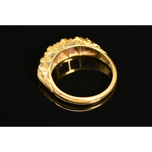 25 - A LATE 20TH CENTURY 18CT RUBY AND DIAMOND CARVED HALF HOOP FIVE STONE RING, scroll carved shoulders ... 