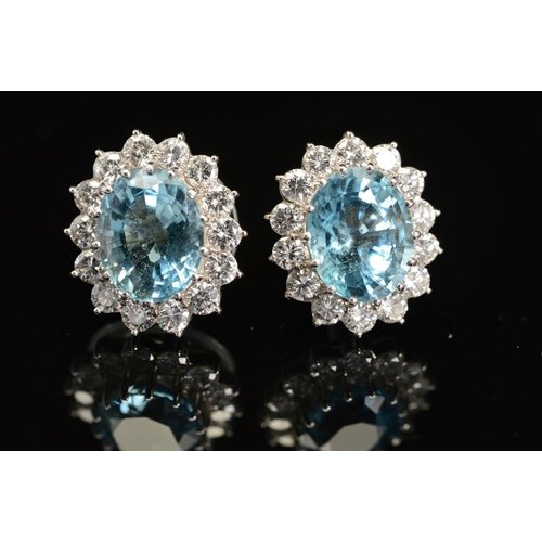 27 - A PAIR OF MODERN OVAL AQUAMARINE AND DIAMOND CLUSTER EARRINGS, post fittings, measuring approximatel... 