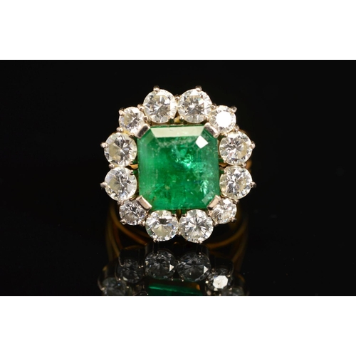 28 - A LATE 20TH CENTURY LARGE EMERALD AND DIAMOND CLUSTER RING, emerald cut emerald measuring approximat... 