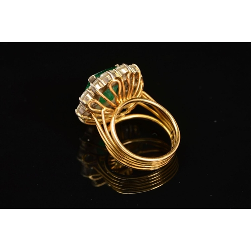 28 - A LATE 20TH CENTURY LARGE EMERALD AND DIAMOND CLUSTER RING, emerald cut emerald measuring approximat... 