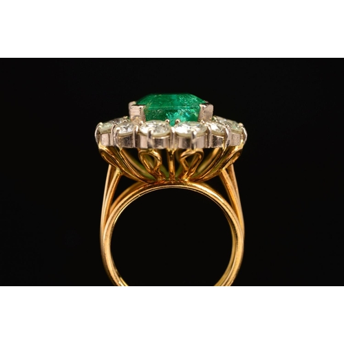 28 - A LATE 20TH CENTURY LARGE EMERALD AND DIAMOND CLUSTER RING, emerald cut emerald measuring approximat... 