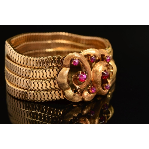 30 - A CONTINENTAL FOUR ROW SNAKE BRACELET, fitted to large feature scroll design clasp set with rubies, ... 