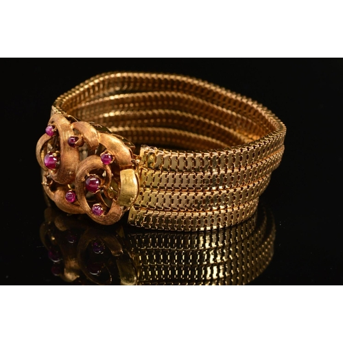 30 - A CONTINENTAL FOUR ROW SNAKE BRACELET, fitted to large feature scroll design clasp set with rubies, ... 