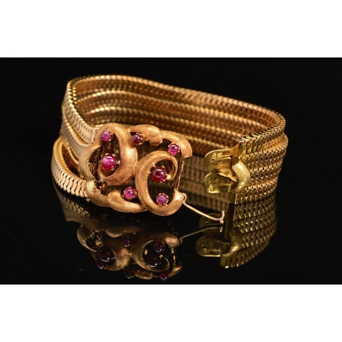 30 - A CONTINENTAL FOUR ROW SNAKE BRACELET, fitted to large feature scroll design clasp set with rubies, ... 