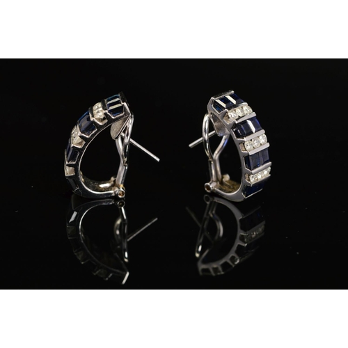 32 - A PAIR OF MODERN SAPPHIRE AND DIAMOND HOOP STYLE EARRINGS, post and omega clip fitting, comprised sq... 