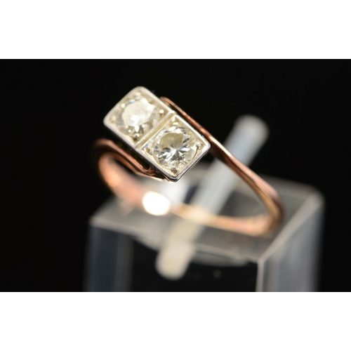 36 - A MID 20TH CENTURY TWO STONE DIAMOND RING, each diamond grain set within a box setting, cross over d... 