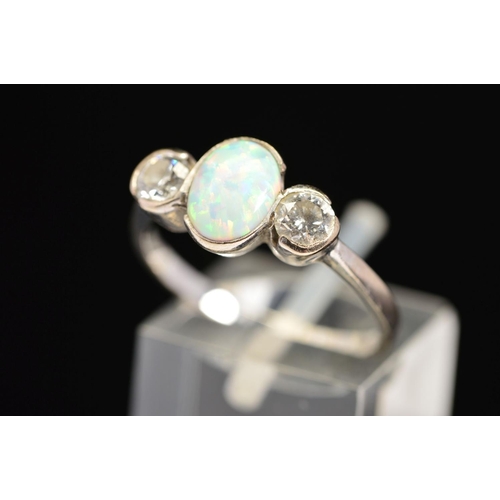 37 - AN 18CT WHITE GOLD, OPAL AND DIAMOND RING, designed as a central oval opal cabochon flanked to eithe... 