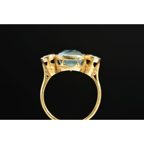 39 - A MID TO LATE 20TH CENTURY AQUAMARINE AND DIAMOND THREE STONE RING, centring on a cushion mixed cut ... 