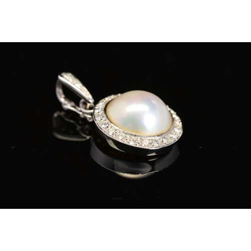 41 - A MODERN 18CT WHITE GOLD MABE PEARL AND DIAMOND PENDANT, a round Mabe pearl enclosed within a border... 